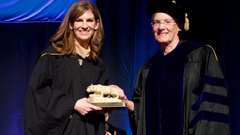 Jennifer Morgan is presented a nittany lion statue from Kristin Woolever