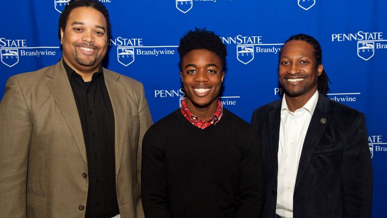 Student stands with scholarship donor.