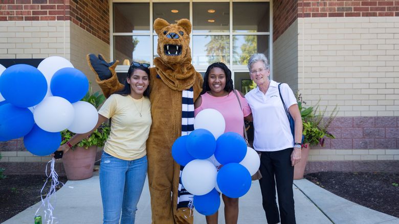 Chancellor Kristin Woolever congratulates Myeisha Matos and Donna Aggie