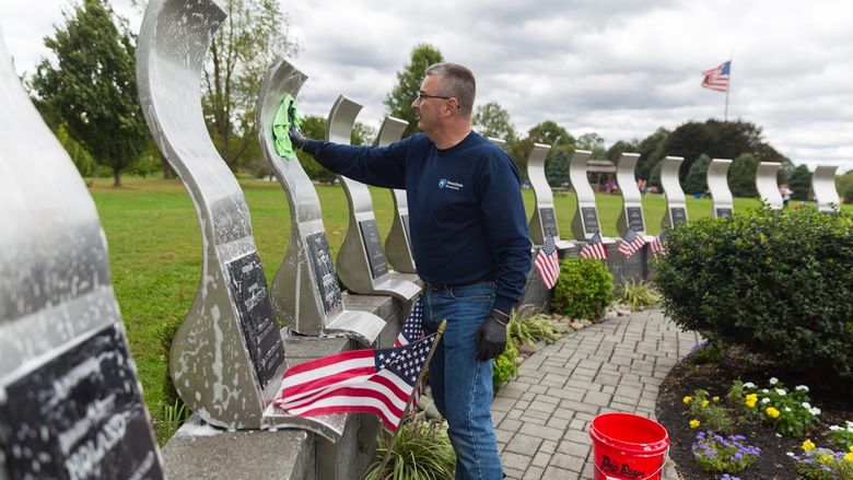 Bill Tyson cleans the Delaware County Law Enforcement Memorial