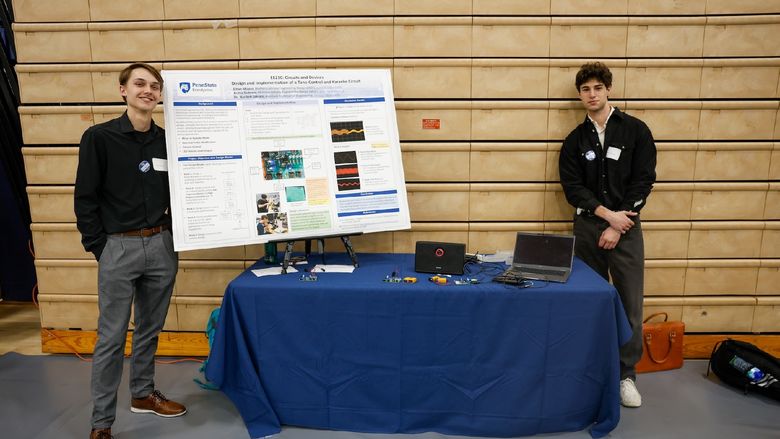 students presenting work on poster