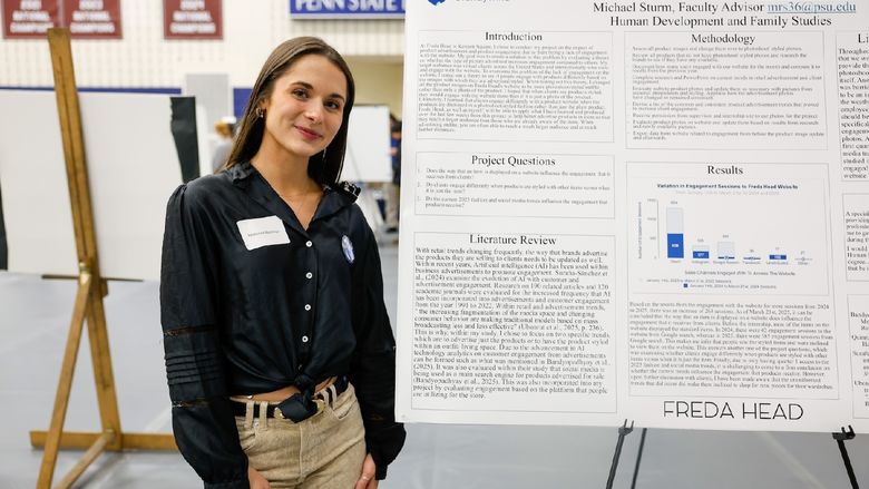 student presenting work on poster