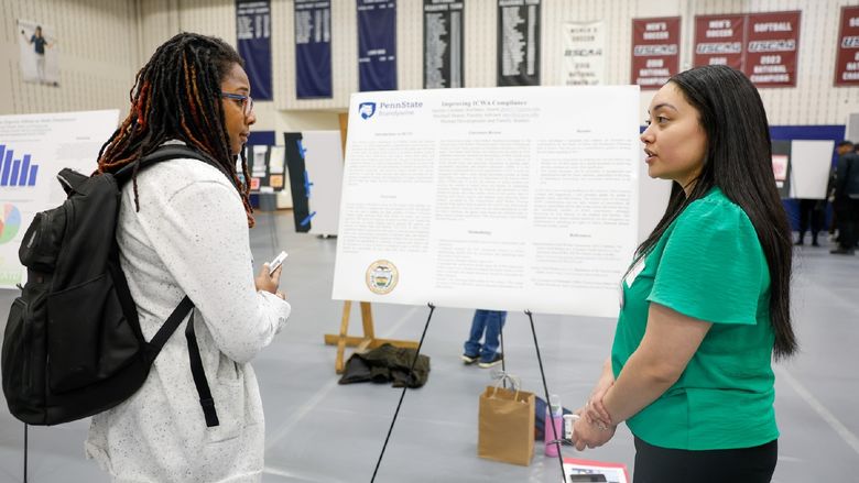 student presenting her internship work to a professor