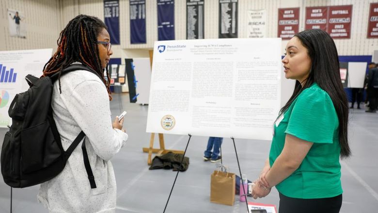 student presenting her internship work to a professor