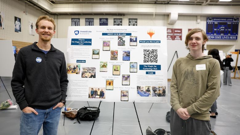 students presenting club on poster board