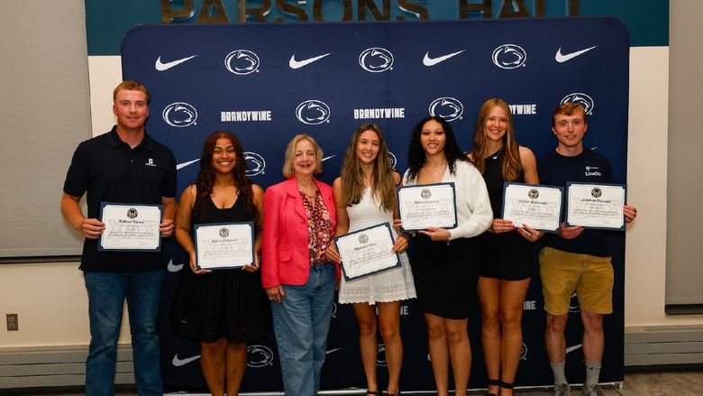 students with chancellor holding certificates