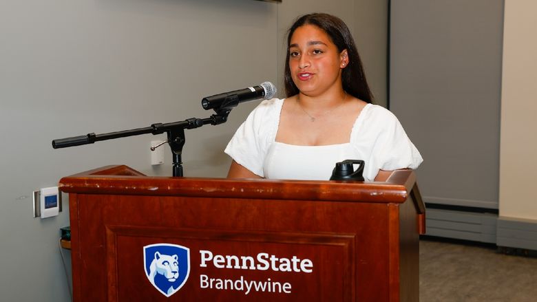 student talking at podium