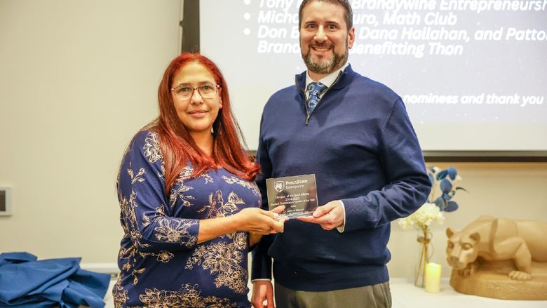two people holding an award