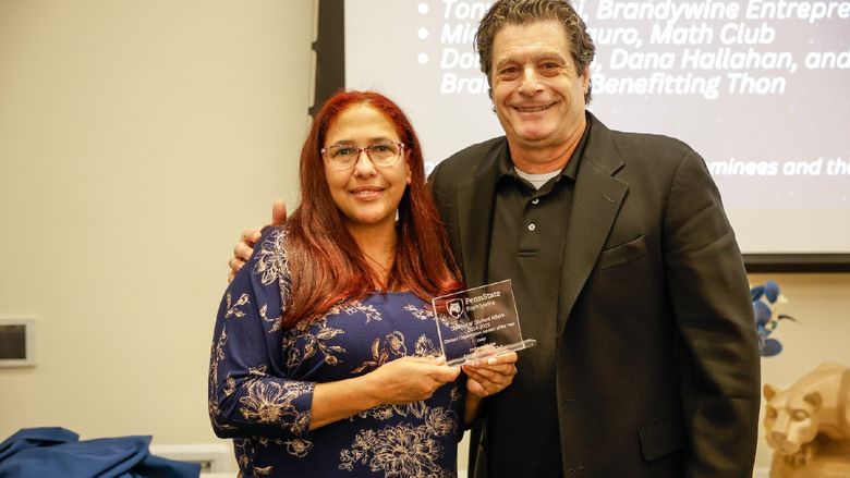 two people holding an award