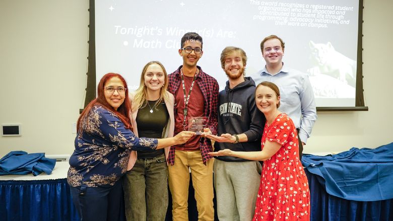 group of people holding award