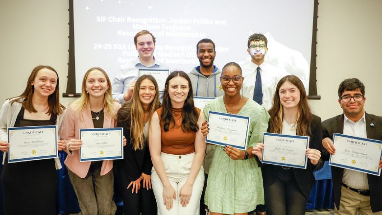 students holding certificates