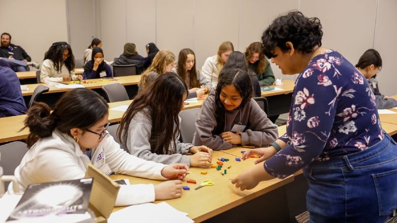 woman helping students with workshop