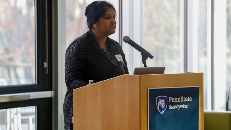 woman speaking into podium