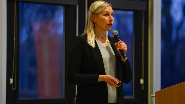 woman speaking into microphone