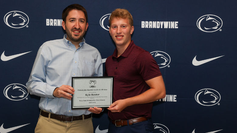 two men holding certificate