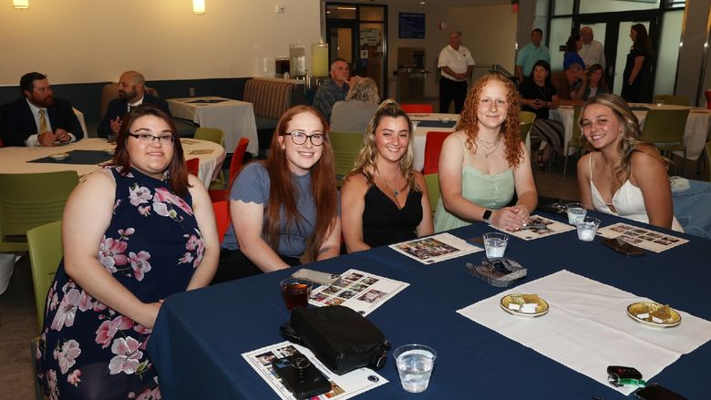 five women sitting at a table