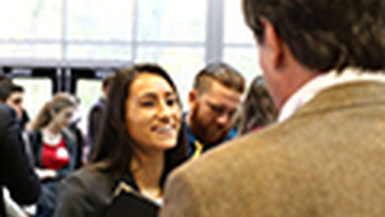 students talking to alumni at career fair