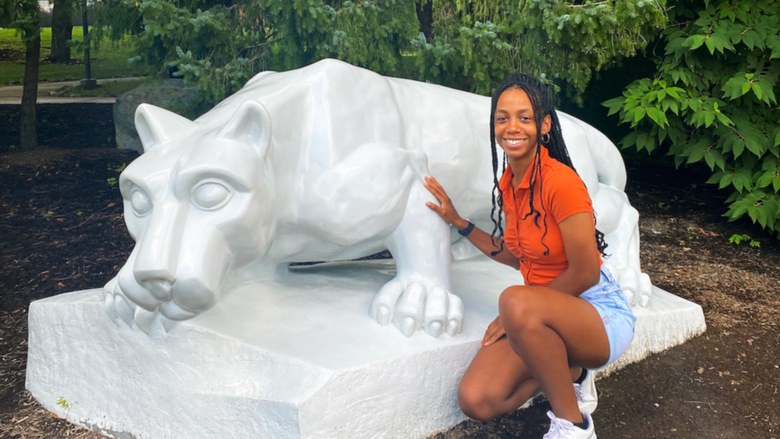 Angel Asomugha next to the Lion Shrine at Penn State Brandywine
