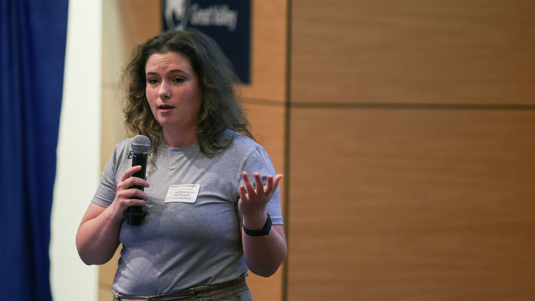 woman on stage with a microphone
