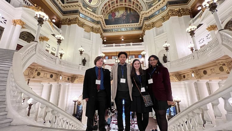 Four students stand in the rotunda of the Pennsylvania Capitol.