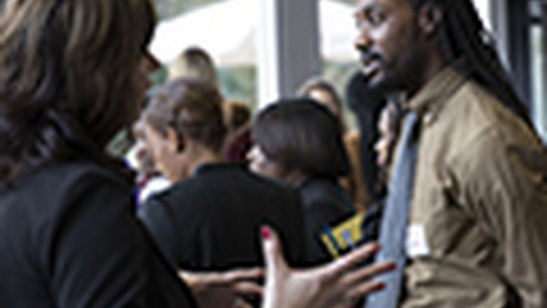 student speaking with an employer at a career fair