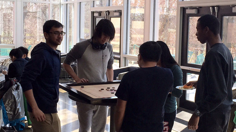 At the March Board Game Break, participants learned the Indian game of Carrom.