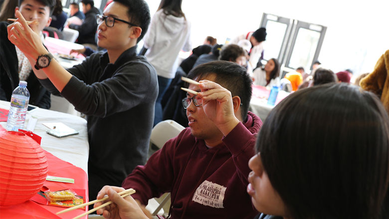 At the event, some students taught everyone how to use chopsticks.
