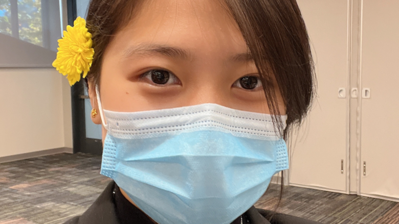 Victoria Zhang wearing a mask with a flower in her hair