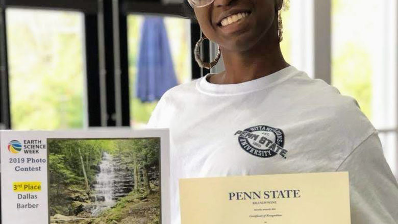 Dallas Barber displays her photo entry at the 2019 Earth Science Week Photo Contest. 