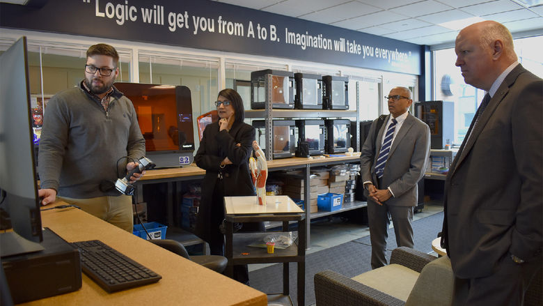 Instructor demonstrates something on computer screen for Bendapudi