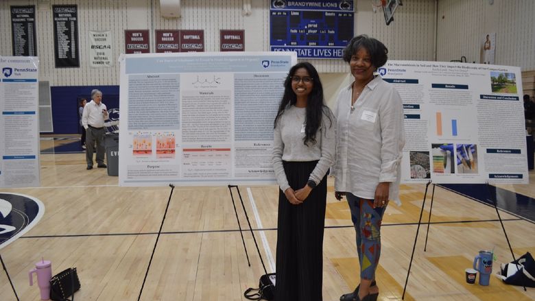 student and professor with poster