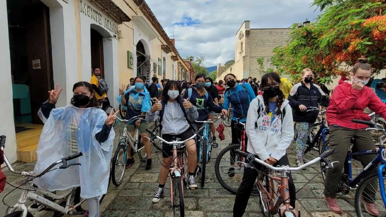 Students riding bicycles through Oaxaca
