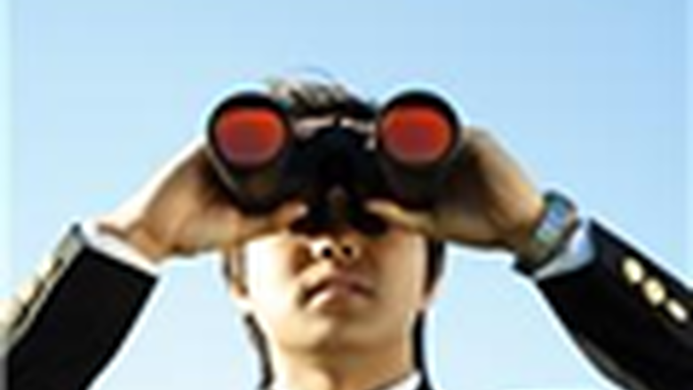 man looking though binoculars