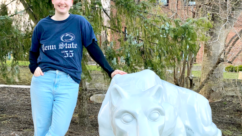 Gracie Guerin standing next to Nittany Lion statue, Penn State's mascot