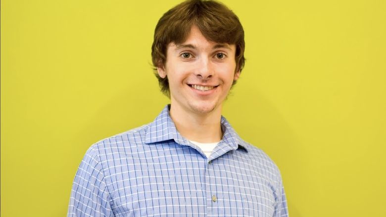 Man standing in front of bright yellow background