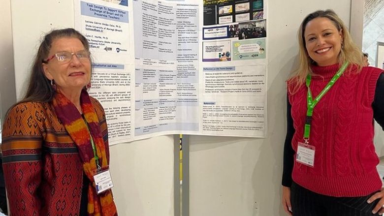 Two women giving a poster presentation