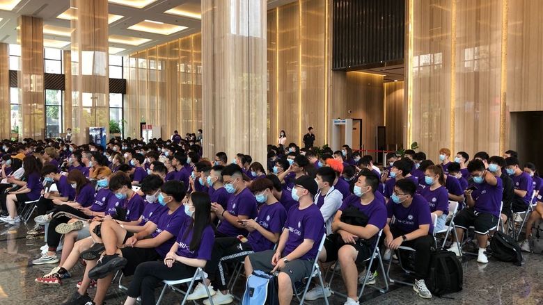A group of students in a large hall for orientation