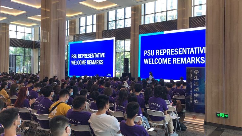 Students sitting in a large hall for orientation