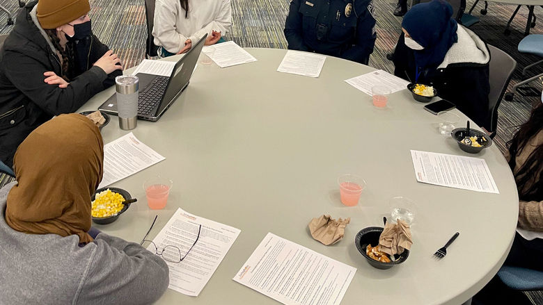 Members of the Brandywine community sitting around a round table 