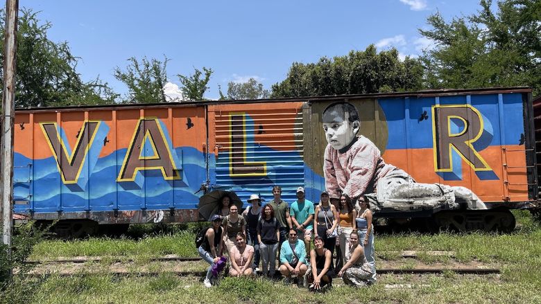 students in front of train
