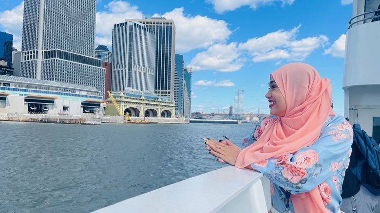 Brandywine student Jannat Chowdhury looks at the Manhattan skyline from aboard a harbor cruise boat.