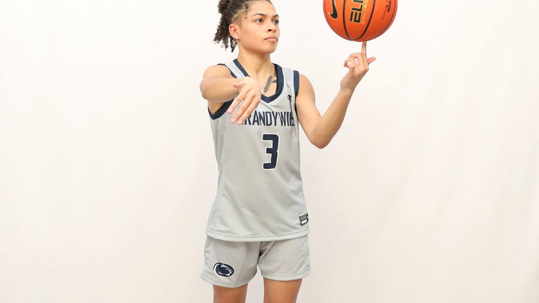 Jenaya Smith wearing Brandywine women's basketball jersey, number 3, spinning a basketball in her hand