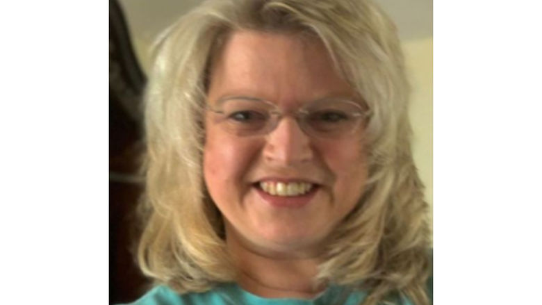 woman wearing green shirt smiling