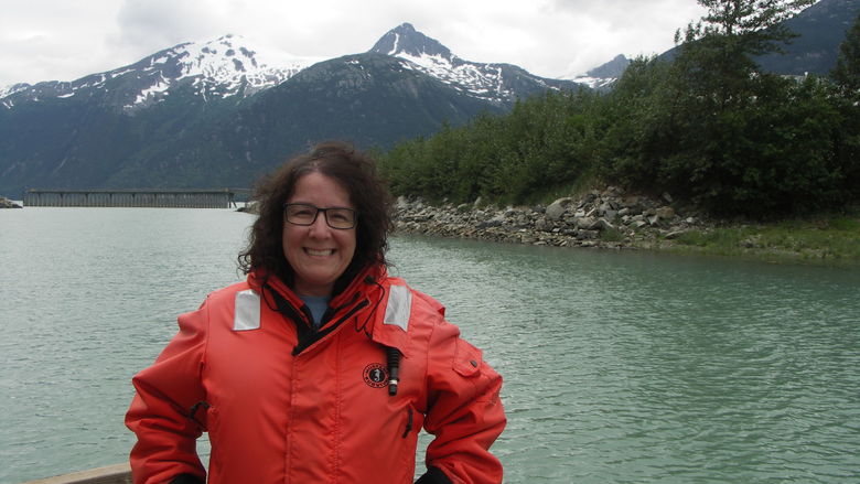 Professor Laura Guertin standing on the deck of a ship at sea.