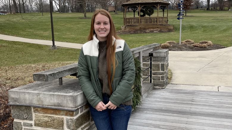 Student standing on bridge on the Penn State Brandywine campus.