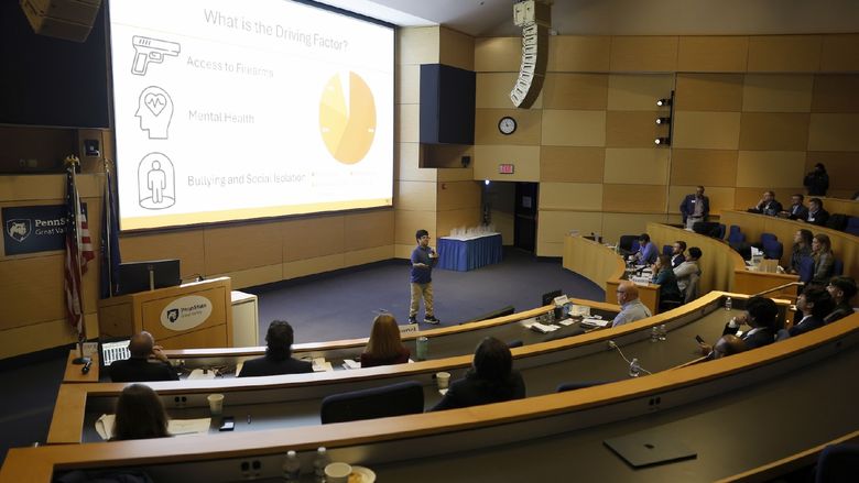 person speaking in front of a crowd
