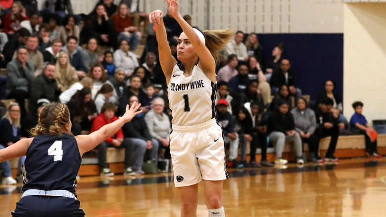 Nikki Velez sinks a three-pointer over the out-stretched arm of a defender