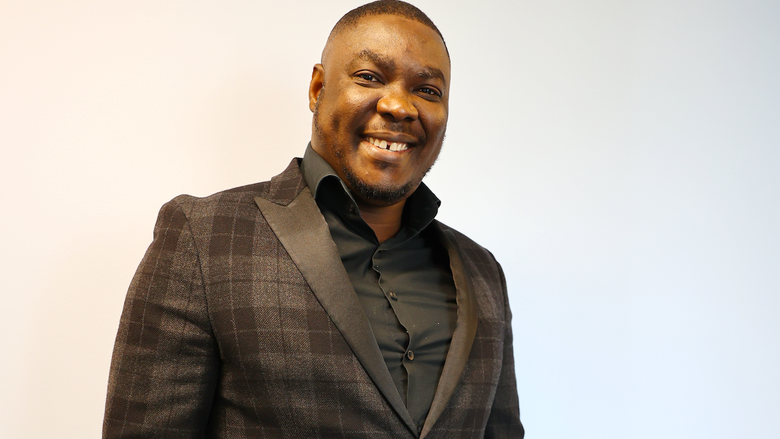 Olugbenga's smiling for his headshot 
