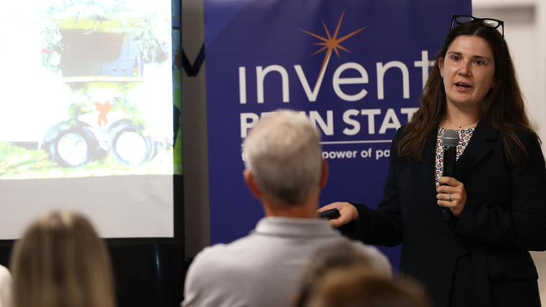 A woman with a microphone speaking to an audience
