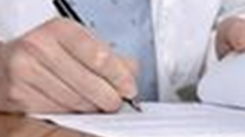 a hand writing on paper